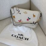 Coach Nolita 19 wristlet in refined pebble leather with a Dreamy Veggie print.