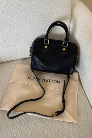 Louis Vuitton Speedy Bandoulière 20 is crafted from black Monogram